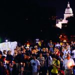 group gathered at night outside of capital