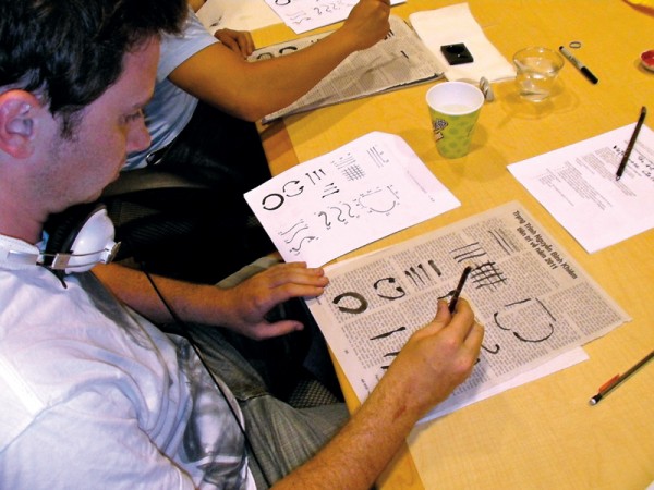 A student practices calligraphy at a weekly guest lecture with local Vietnamese artist Duong Phuoc Luyen. Courtesy of the Summer Language Institute