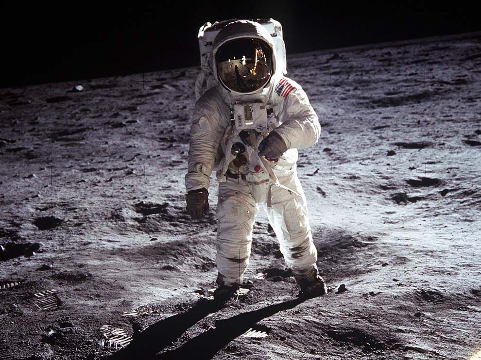 U.S. astronaut in space suit standing on the moon.