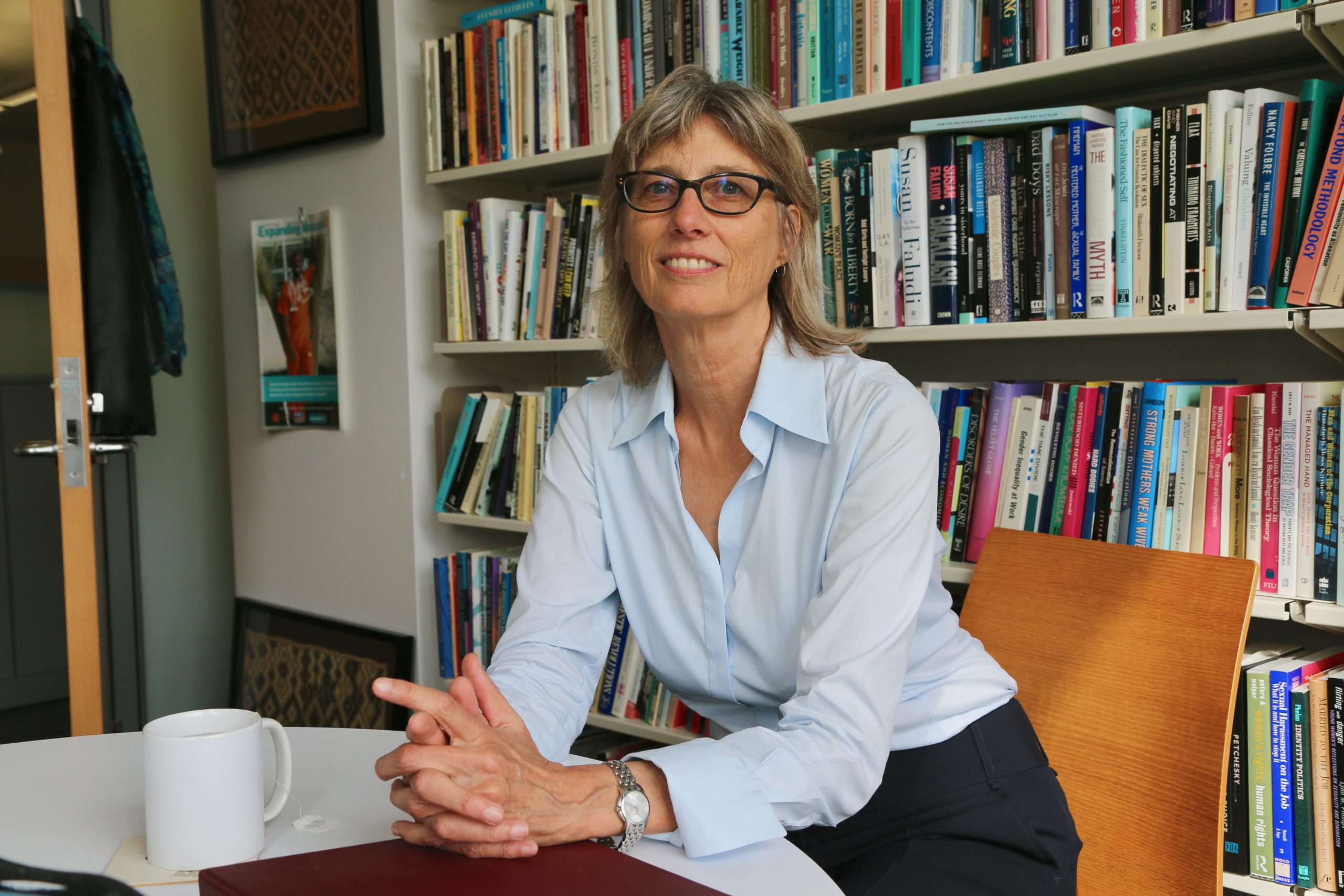 Christine Williams with bookshelves in background.