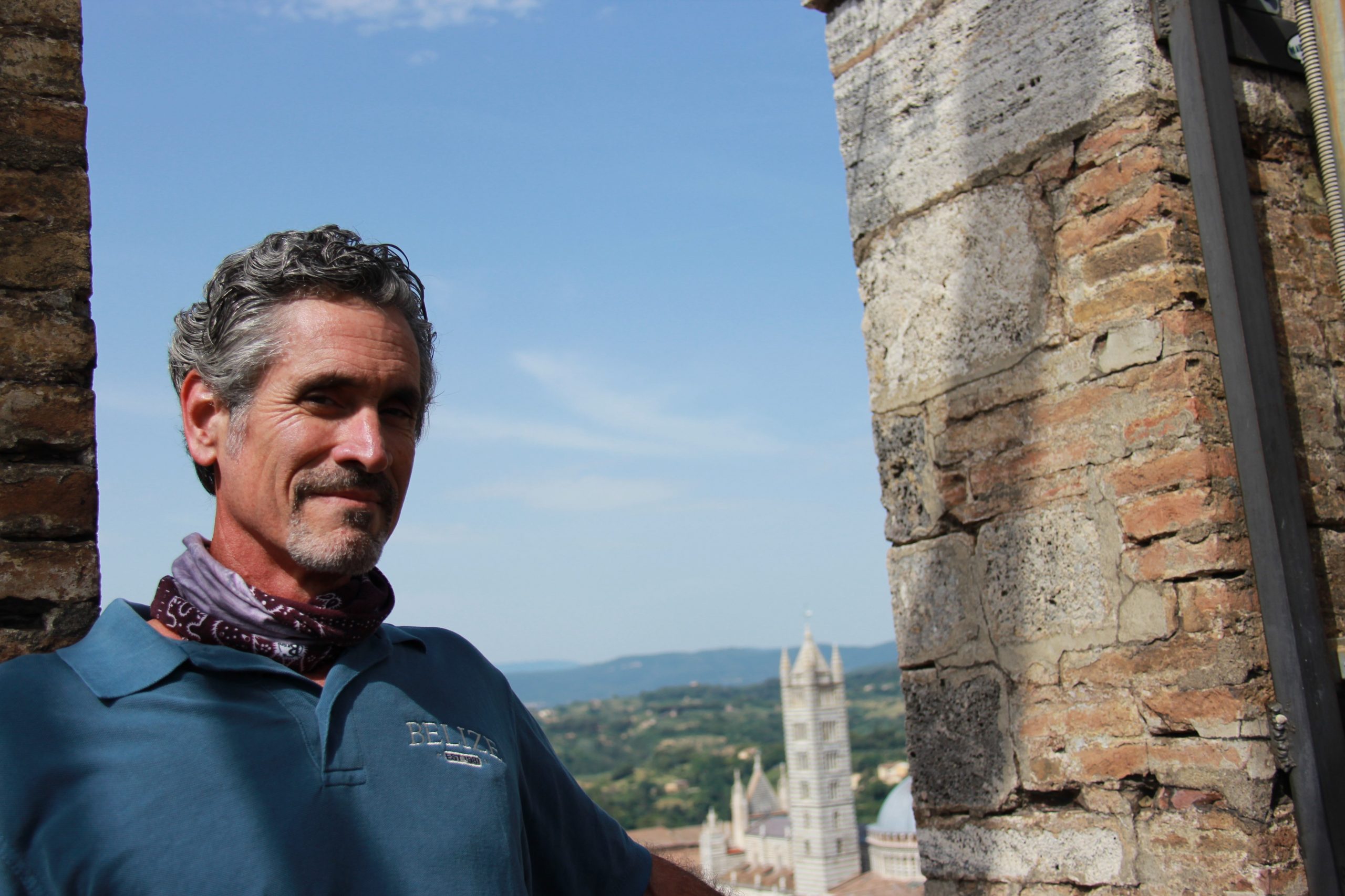 Co-author of the study Timothy Beach stands in next to old stone ruins on site at a dig.